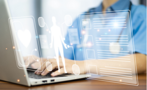 person in blue shirt working on a laptop. Superimposed images of the human body and a heart imply they are working on a healthcare file